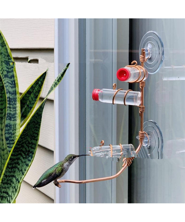 Handmade copper hummingbird feeder with suction cup, transparent PET bottles, and elegant design, perfect for gardens and outdoor spaces.

